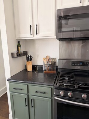 A kitchen with a microwave, stove, and cabinets. - Kenosha Retreat - Created to Help You Relax (Kenosha)