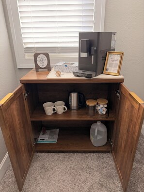 A coffee station with a coffee maker, mugs, a kettle, and a framed welcome sign. - Kenosha Retreat - Created to Help You Relax (Kenosha)