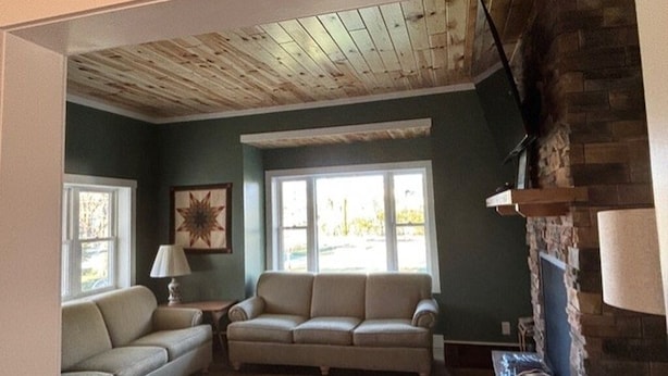 A living room with a fireplace, two sofas, a lamp, and a star-shaped wall decoration. - Perfect Mackinaw City Location! One block to Downtown, Ferry, or Waterfront (Mackinaw City)