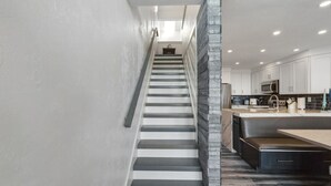 Eine moderne Küche mit weißen Schränken, einer schwarzen Arbeitsplatte und einem Edelstahlspülbecken.