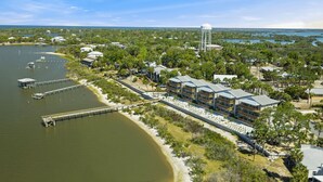 A coastal hotel with multiple buildings, a dock, and a water tower.