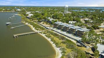 A coastal hotel with multiple buildings, a dock, and a water tower.