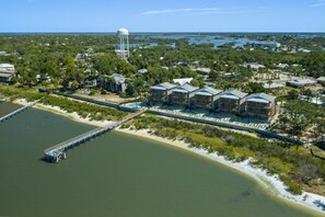 A coastal hotel with a water tower, a dock, and a beach view. - Seahorse Sunset at Seahorse Landing (Cedar Key)