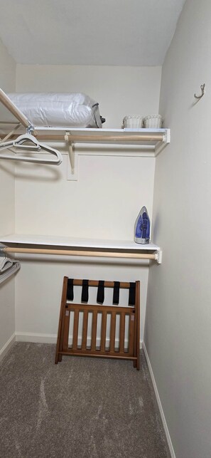 A bunk bed with a wooden frame and a mattress on the top bunk.