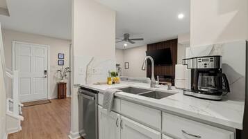 Open, pass through counter area is great for bonding around meal prep, meals, and clean up. Dishwasher and deep stainless steel double sink makes clean up easy.