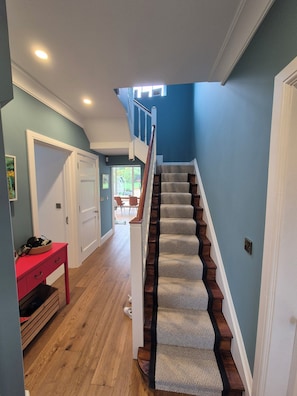 A staircase with wooden steps and a carpeted handrail, leading to a second floor. - Fabulous 4-bedroom family home in tranquil Dublin neighborhood 10 mins from town (Dublin)