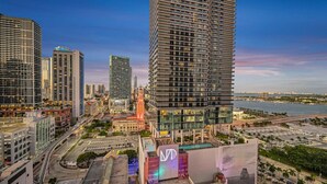 A high-rise building with a modern design, surrounded by other tall buildings and a waterfront. - Casa Marina – Skyline Views Luxury Downtown Tower (Miami)