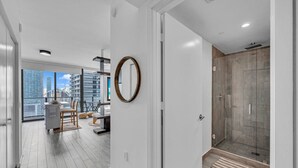 A modern interior with a dining area, a large mirror, and a walk-in closet. - Casa Marina – Skyline Views Luxury Downtown Tower (Miami)