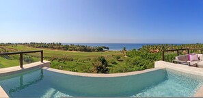 A swimming pool with a view of the ocean and a grassy area with trees. - Condo Argo in Punta Mita (Punta de Mita)