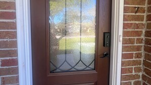 A brown door with a glass panel and a metal handle. - Beautiful 2-bedroom house with AC in peaceful Palm Valley (Palm Valley)