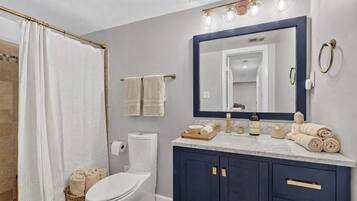 Shower, hair dryer, towels, shampoo