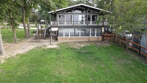 A two-story house with a balcony, a fenced yard, and a wooden deck. - Lakeview Lookout - Stunning Views! (Tool)