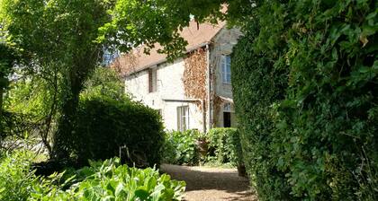 Nécy Country house, large enclosed garden with trees.