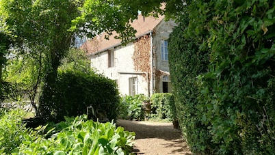 Nécy Country house, large enclosed garden with trees.