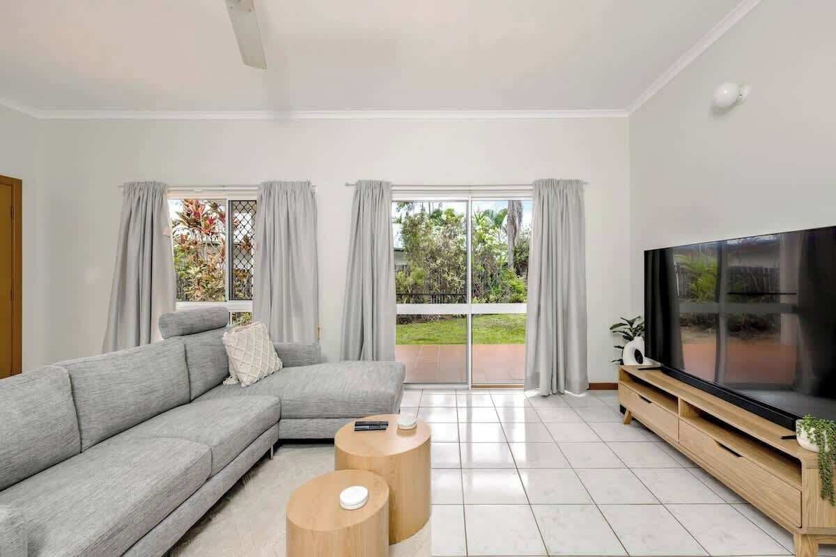 The light-filled living room is complete with a sofa, chaise and TV for relaxed movie nights, while split system air-conditioning and ceiling fans ensure year-round comfort. 
