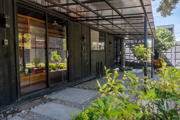 A modern building with large windows and a covered outdoor area. - STEELCRAFT HOTEL (Panajachel)