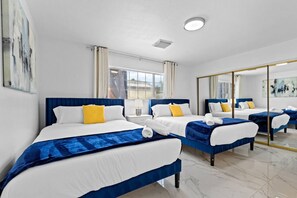 A hotel room with two beds, a large mirror, and a view of the city. - Spacious 7BR/5BA 8 Beds w/Hot Tub | Near & Airport (Las Vegas)