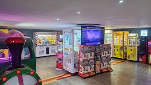 A variety of arcade games and claw machines in a brightly lit indoor space. - Mkrj Premium - Parkdean Camber Sands - (Rye)