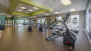 A spacious gym with cardio machines, mirrors, and a wooden floor. - Oceanfront 2BR Villa at Cape Canaveral Beach Resort – Space & Sun (Cape Canaveral)
