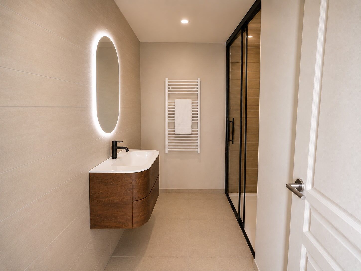 A modern bathroom with a vanity, a mirror with a light, and a towel rack.