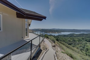 A modern building with a balcony overlooking a scenic landscape.