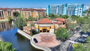 A hotel with a central courtyard, a body of water, and a parking area. - Apt Resort 3br, Sleeps 10 Disney 10 min (Orlando)