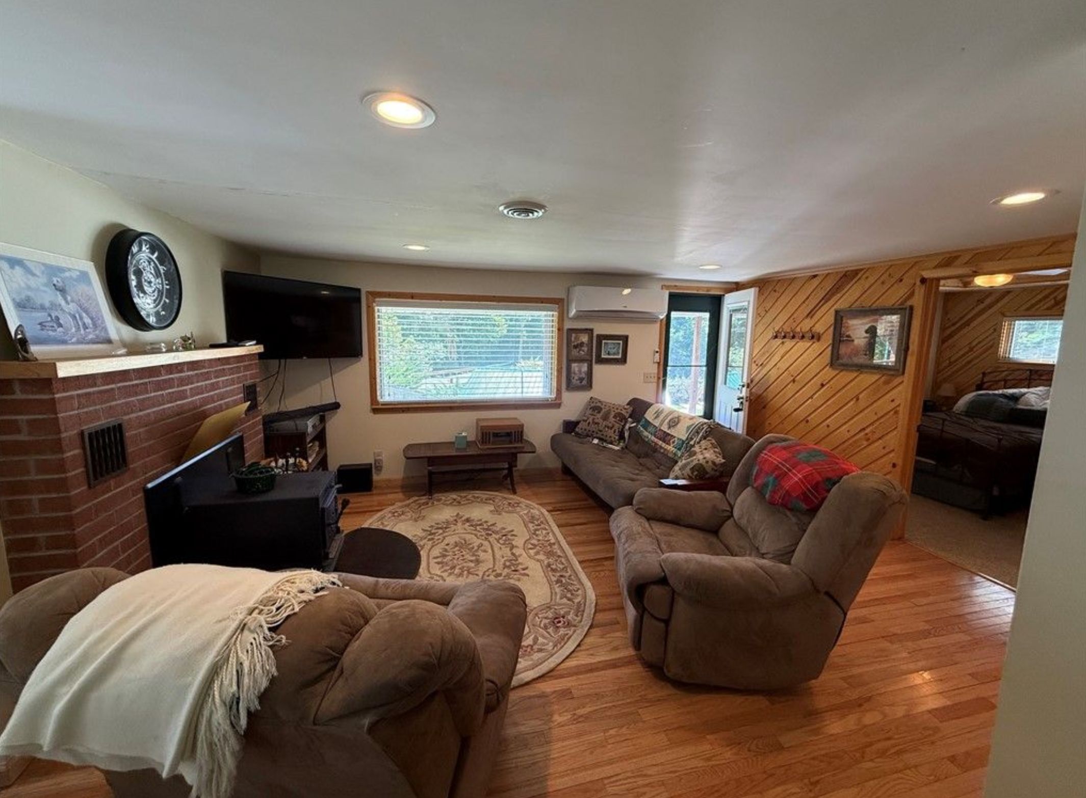 A cozy living room with a fireplace, a television, and a comfortable seating area.