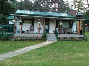 A single-story house with a porch, a front door, and a small front yard. - Clear Lake Retreat • Big Deck • Fire Pit • Views (Tionesta)