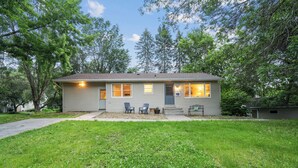 A single-story house with a front porch, two chairs, and a small table. - Quaint Stillwater Retreat Minutes from Historic Downtown - Lilac Apartment (Stillwater)