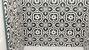 A bathroom with black and white patterned tiles, a shower area, and a visible drain. - Pet friendly Brand new home in Central Oklahoma City (Oklahoma City)