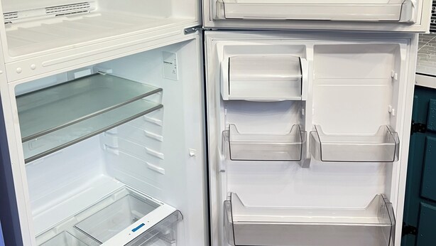 An open refrigerator with multiple shelves and drawers, a control panel, and a water dispenser. - Pet friendly Brand new home in Central Oklahoma City (Oklahoma City)