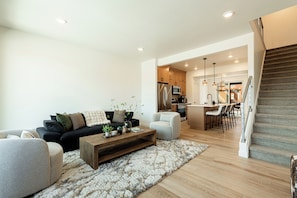 A modern living room with a sofa, armchair, coffee table, and a rug. - Adventure Awaits-Hike, Bike, Ski & Water Sports All Just Minutes Away (Heber City)