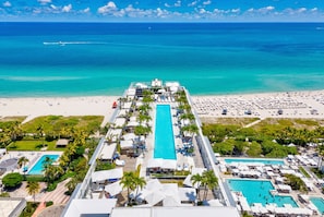 A resort with a central swimming pool, multiple smaller pools, and a beach area. - 1 Hotel South Beach,1BR/1.5BA, Beachfront Access, Balcony (Miami Beach)