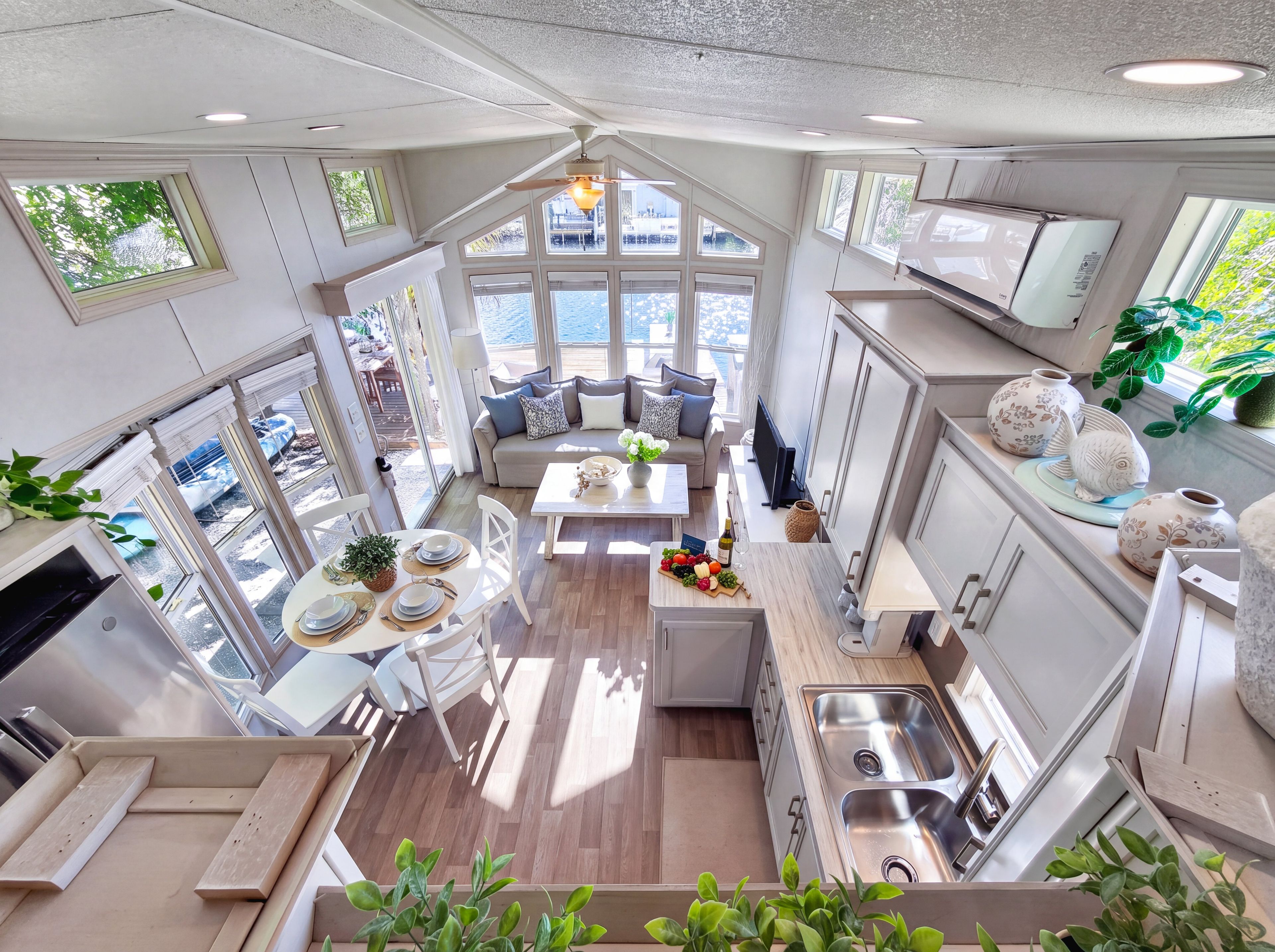 A modern kitchen with a central island, ample natural light, and a view of the outdoors.
