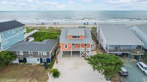 A beachfront property with multiple buildings, a sandy beach, and the ocean in the background. - "Heavenly View" 5 Bedroom, 4 Bathroom, Oceanfront with Private Pool PET FRIENDLY! (Holden Beach)