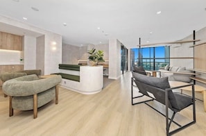 A modern interior with a reception desk, seating area, and large windows. - Good Vibes 1 Bedroom Apartment Brisbane CBD (Brisbane City)