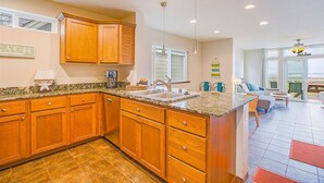 A kitchen with wooden cabinets, a granite countertop, and a large island. - Beachfront Home w/ Hot Tub | Sleeps 9 | Dogs OK (Ocean Shores)