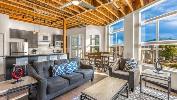 A modern interior with a kitchen, dining area, and seating space. - Bremerton Bay Condo | Walk to Ferry | Unit 201 (Bremerton)