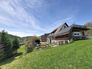 A house with a sloped roof, a covered porch, and a small deck area. - Scherzingers Fewo by Interhome (Eisenbach)