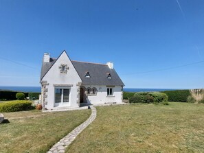 A house with a stone facade, a steeply pitched roof, and a view of the sea. - Le Vauglin by Interhome (Planguenoual)