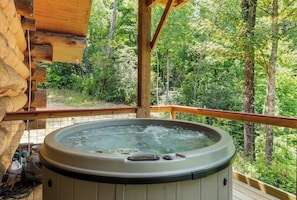 A hot tub on a wooden deck with a view of a forest. - The Missing Peace Cabin - Hot Tub, Private 3BR Mountain Reset Near Pisgah Nat’l (Brevard)