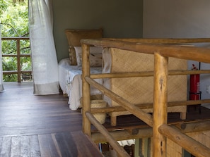 A wooden deck with a bed and a fire extinguisher. - Hotel Boutique Quinta Três Marias (Paracuru)