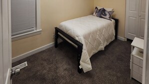 A bedroom with a bed, a ceiling fan, a window with blinds, a wardrobe, and a carpeted floor. - Bright & Quiet 2 Bd Nest / 1st FL Getaway (Chicago)