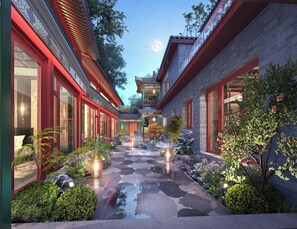 A courtyard with traditional architecture, stone pathways, and illuminated lanterns. - Happy Dragon Imperial Garden Courtyard  (Beijing)