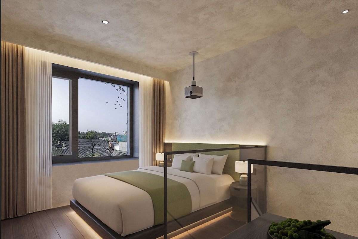A modern hotel room with a large bed, a view of the city, and a balcony.