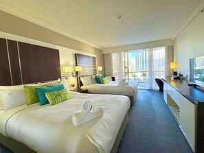 A hotel room with two beds, a desk, and a view of the city. - L7 Ocean View Studio with 2 Beds+Netflix (Surfers Paradise)