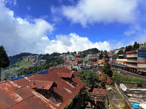 A hillside town with traditional buildings, a prominent yellow-domed structure, and a visible satellite dish. - Pushparaj Near New Marine Drive Rd (Puri)