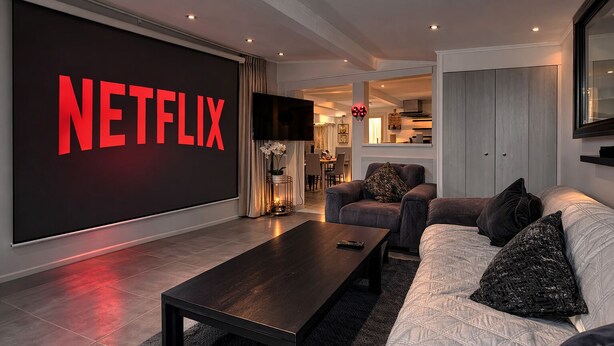 A modern living room with a large flat-screen TV, a dark wooden coffee table, and a sofa with decorative pillows. - Chalet-type house for 7 people with swimming pool near Disneyland Paris (EuroDisney) (Villiers-sur-Morin)