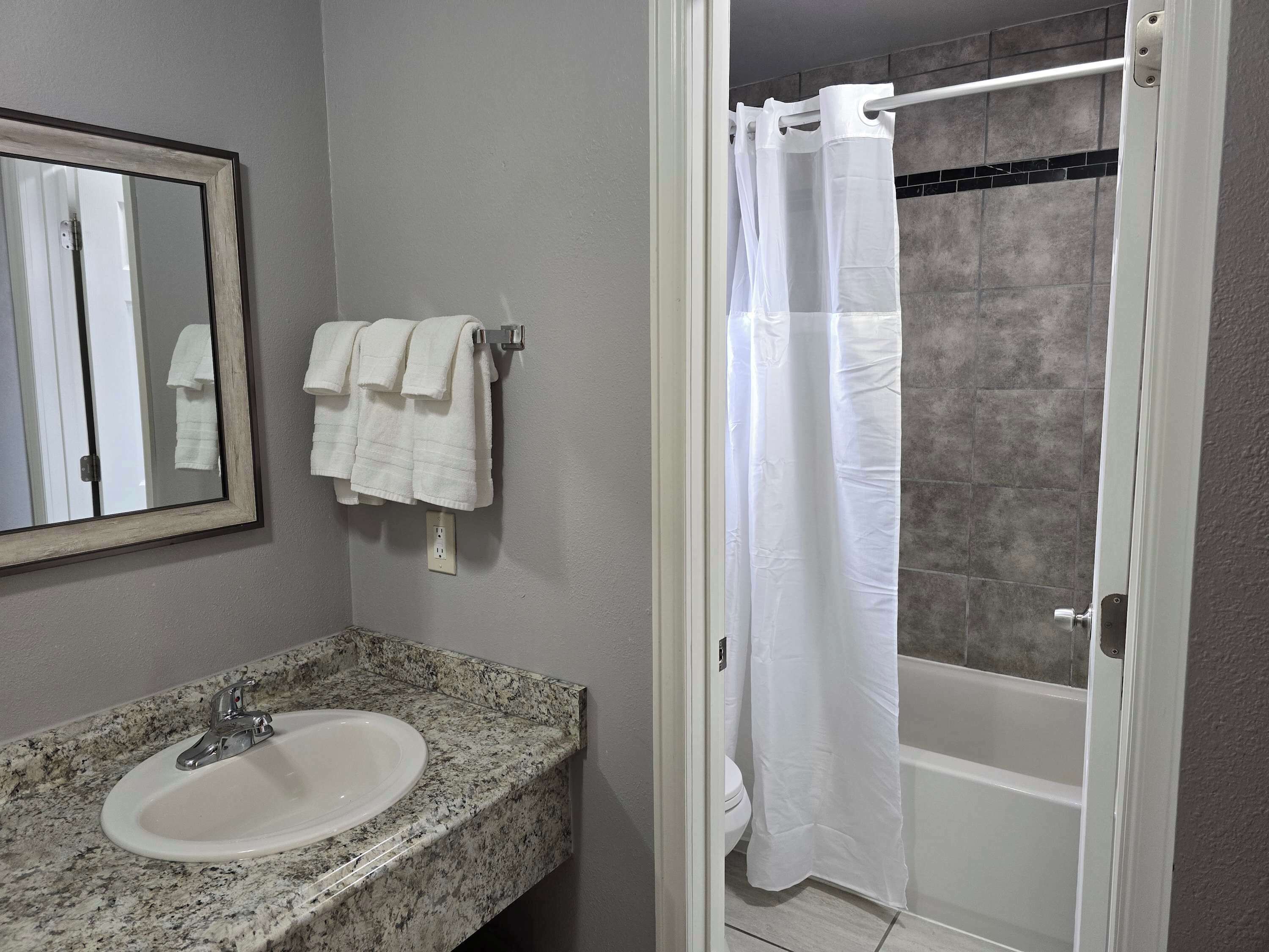 Shower, hair dryer, towels, shampoo