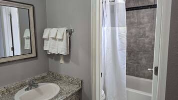 Shower, hair dryer, towels, shampoo